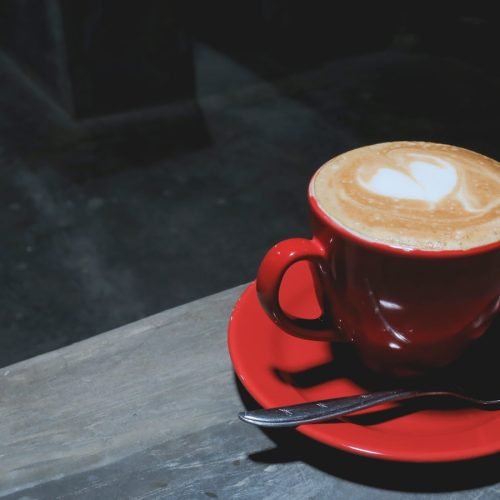 a cup of coffee with a spoon on a saucer